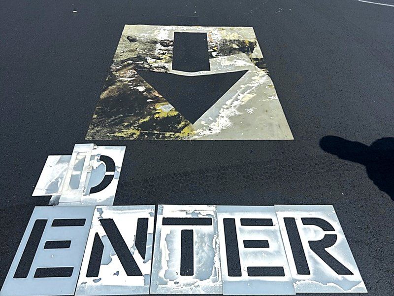 ENTER stencil freshly painted at a parking lot entrance