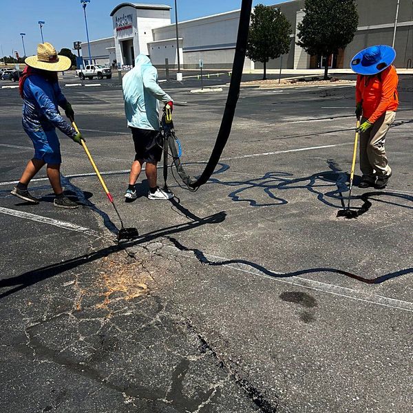 Heartland crew hot-sealing cracks on a commercial lot
